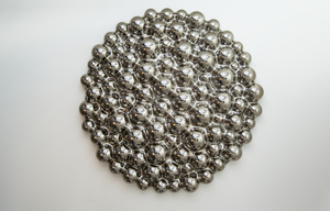 A modern 3D bubbles glass wall sculpture made of reflective mirror spheres