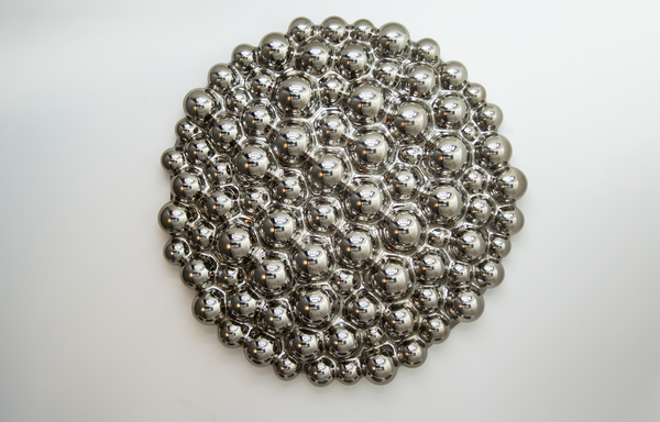 A modern 3D bubbles glass wall sculpture made of reflective mirror spheres