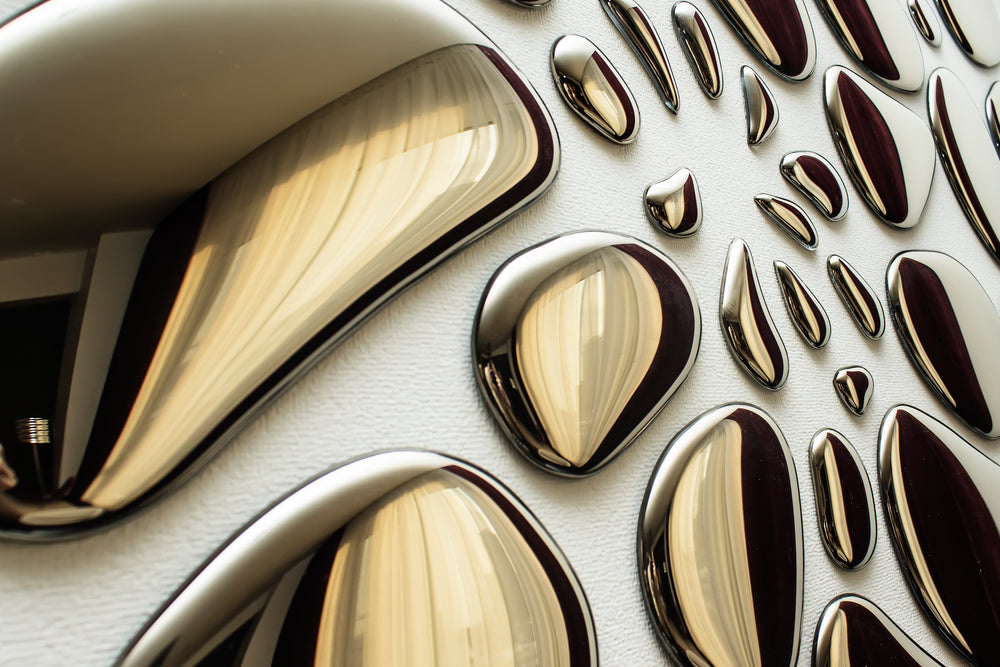Modern glass mirror wall art in an abstract arrangement, enhancing interior aesthetics with a reflective surface.