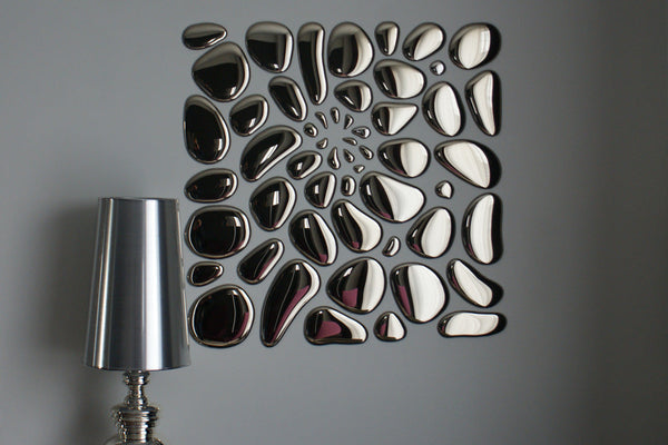 Modern glass mirror wall art in an abstract arrangement, enhancing interior aesthetics with a reflective surface.