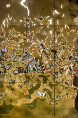 Close-up of Aqua High Wave gold glass panels, showcasing their reflective, wavy texture and luxurious metallic finish.