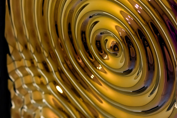 Artistic glass panel with a ripple effect, capturing light and reflections to enhance interior design aesthetics.
