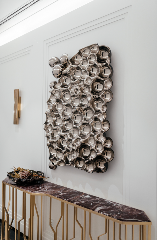 Elegant glass bubbles wall art decor with reflective silver texture in a contemporary interior.