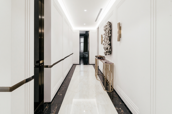 Modern textured glass sculpture with bubbles design, adding depth to a minimalist hallway.