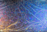 Luxurious chameleon glass wall panel with intricate textures and iridescent hues, reflecting a blend of blue, purple, and gold tones. A modern and artistic decorative glass panel ideal for upscale interiors