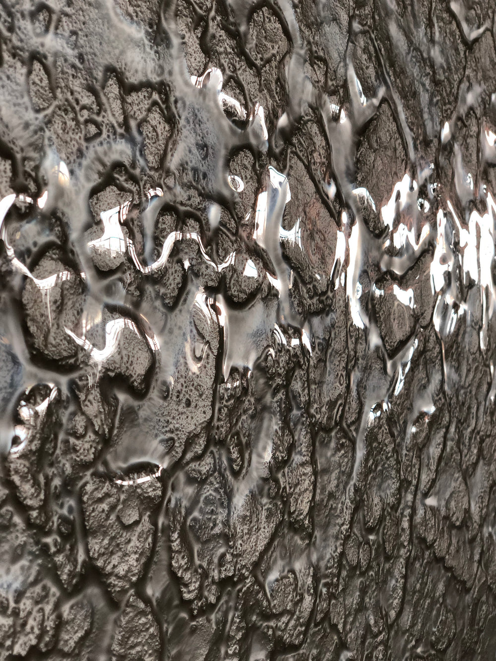 Close-up of champagne glass wall panels showcasing intricate textures and reflective surfaces