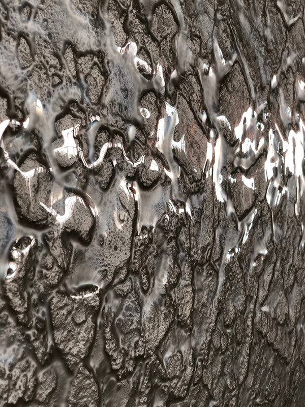 Close-up of champagne glass wall panels showcasing intricate textures and reflective surfaces