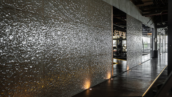 Expansive installation of champagne glass wall panels in a high-end commercial space, seamlessly blending luxury and contemporary design.