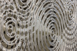 Close-up view of a silver glass panel showcasing detailed ripples and reflections, perfect for modern decor applications.