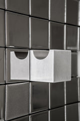 Closeup of designer towel rack with a unique Tetris block layout.