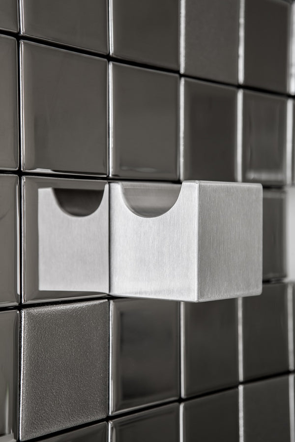 Closeup of designer towel rack with a unique Tetris block layout.