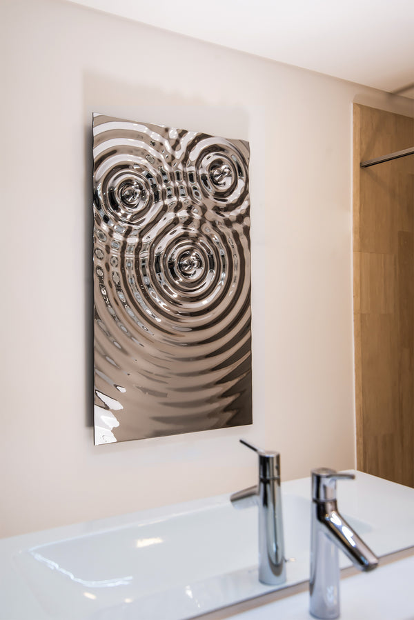 An exclusive designer towel holder with a striking 3D ripple effect in polished gold.

