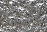 Close-up of Fiama glass wall panel in silver with a highly textured, molten-like luxury surface
