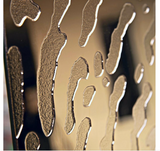 Close-up of fingerprint-inspired glass texture with a reflective gold finish.