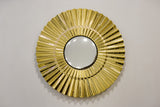 Golden glass sun wall art decor with a reflective convex center on a neutral background.
