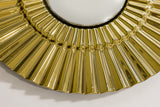 Angled shot of the golden sunburst wall decor highlighting its three-dimensional form