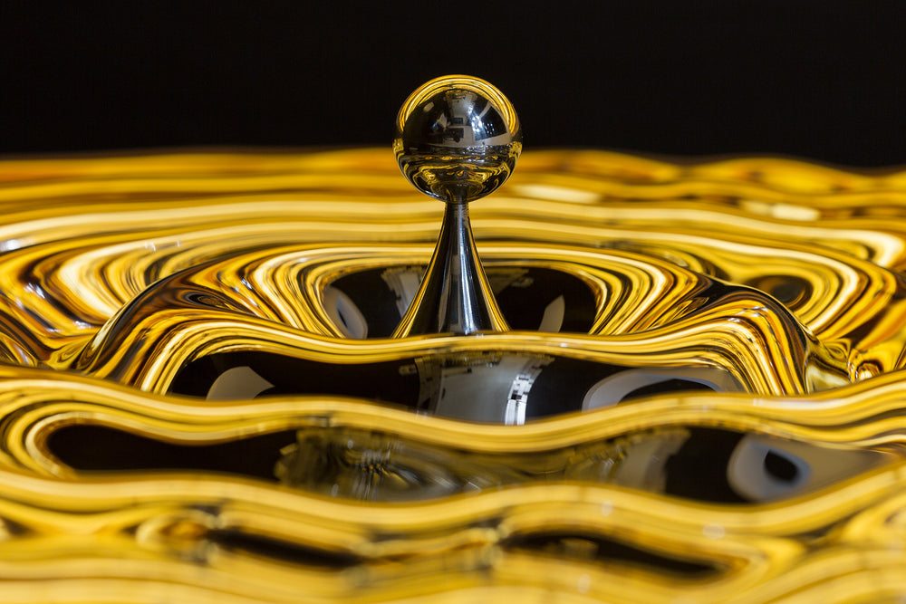 A stunning artistic towel rack with a reflective gold and black finish, adding elegance to any space.