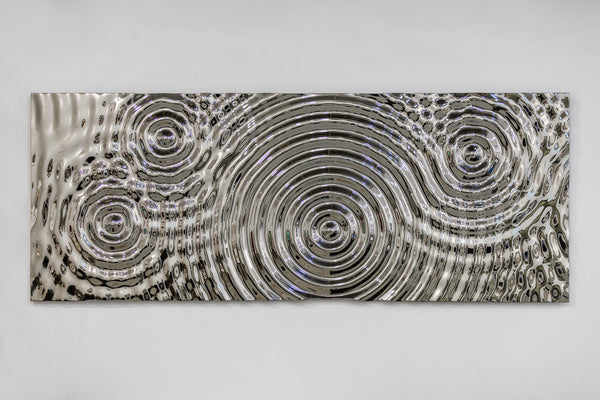 High-gloss mirror wall panel with an intricate ripple design, reflecting light and transforming the interior with contemporary elegance.