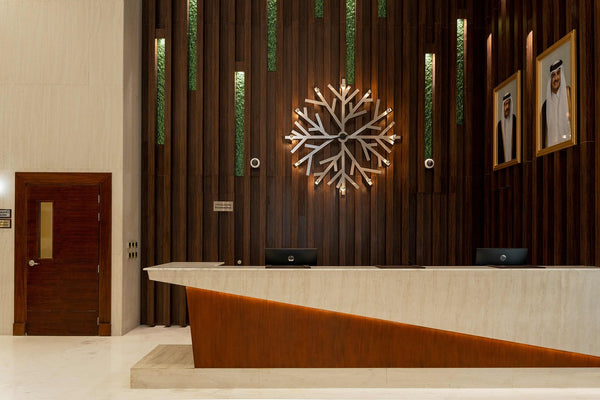 Luxury hotel lobby with wooden paneling and Green Planet glass decorative inlays