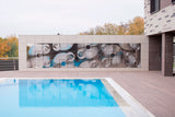 Exterior installation of Interference glass panels near a swimming pool, reflecting the surroundings.