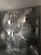 Luxury interior featuring Interference glass panels with polished metallic reflections