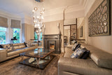 Luxury living room with bespoke glass wall art, featuring elegant mirrored decor and sophisticated interior design.