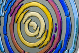 Elegant metallic circle mural with high-gloss titanium-coated glass details, creating a bold artistic statement.
