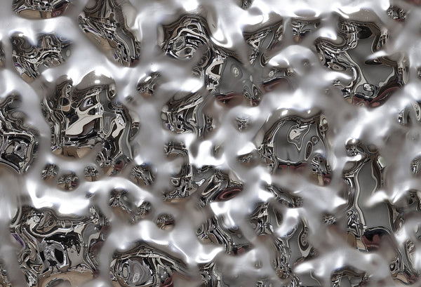 Close-up of the luxury Vento Silver wall panel featuring a textured mirrored glass surface with dynamic reflections.