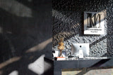Luxury Vento Silver glass wall panels installed in a hotel reception area, showcasing its reflective textured design.
