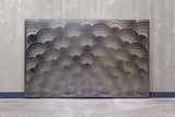 The Mermaid glass wall panel displayed against a concrete wall, showcasing its full design with an elegant wave pattern.