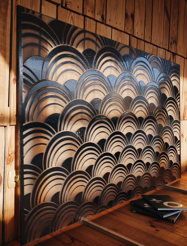 The Mermaid panel installed in a wooden interior, with warm lighting accentuating its sculptural glass design.