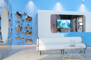 Modern wall art with 3D metallic drops on a blue accent wall in a luxury interior