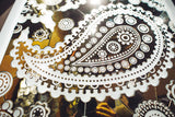 Close-up of the Paisley Pattern – mirrored glass wall panel featuring intricate floral and paisley designs in gold and silver tones.