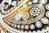Angled close-up shot of the Paisley Pattern mirrored glass wall panel focusing on the ornamental paisley details with a shimmering metallic finish.