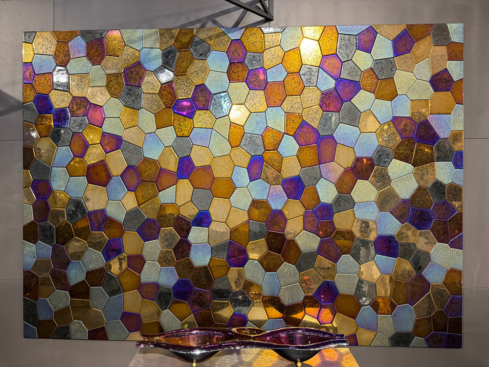 Iridescent glass mosaic wall art with a blend of gold, blue, and bronze hues, creating a mesmerizing decorative accent.
