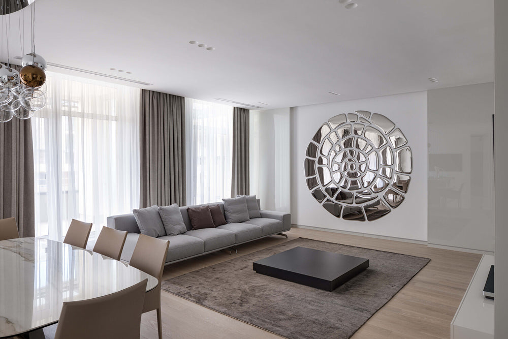Spiral mirror wall art composition in a modern living room