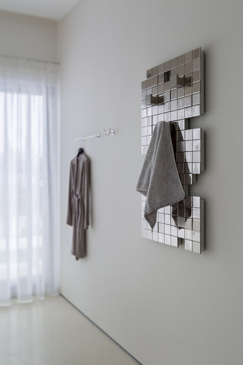 Modern heated towel rack with a stylish Tetris pattern, combining functionality and art.