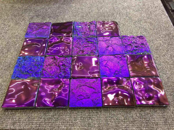 Vibrant purple and blue iridescent glass tiles form a Tetris-style panel. The reflective surfaces create a dynamic, futuristic effect.