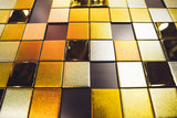 Gold and silver Tetris-style glass wall panel with a mix of glossy and matte finishes, creating a luxurious and geometric aesthetic.