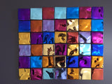 Multicolored Tetris-style glass wall panel with reflective tiles in blue, purple, gold, and red. The high-gloss finish enhances the bold geometric design.