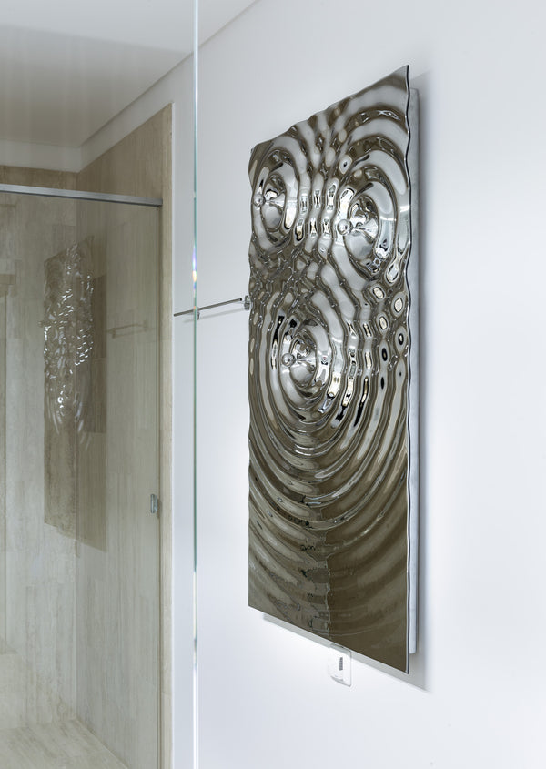 A unique wall-mounted towel holder with a sculptural, fluid-metallic surface.
