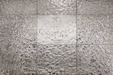  The Vento Silver glass wall panel installed in the Panorama De Luxe hotel, featuring an engraved logo on a mirrored textured surface.