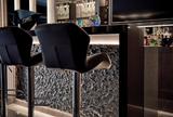 The Vento Silver wall panel used as a decorative element in a high-end lounge bar, emphasizing its intricate glass texture.